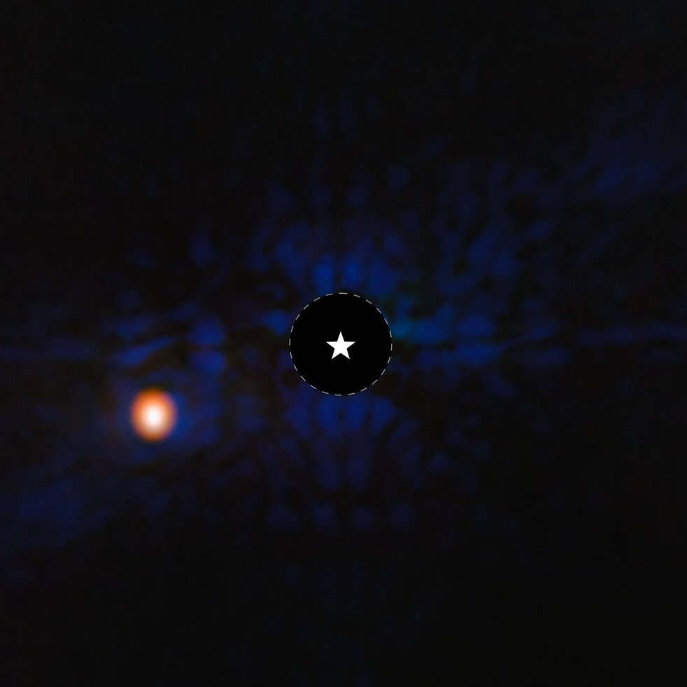 An image of Eps Ind Ab. The image is mostly dark, with residual starlight visible in blue in the center, and the planet as a bright red blob in the lower left.